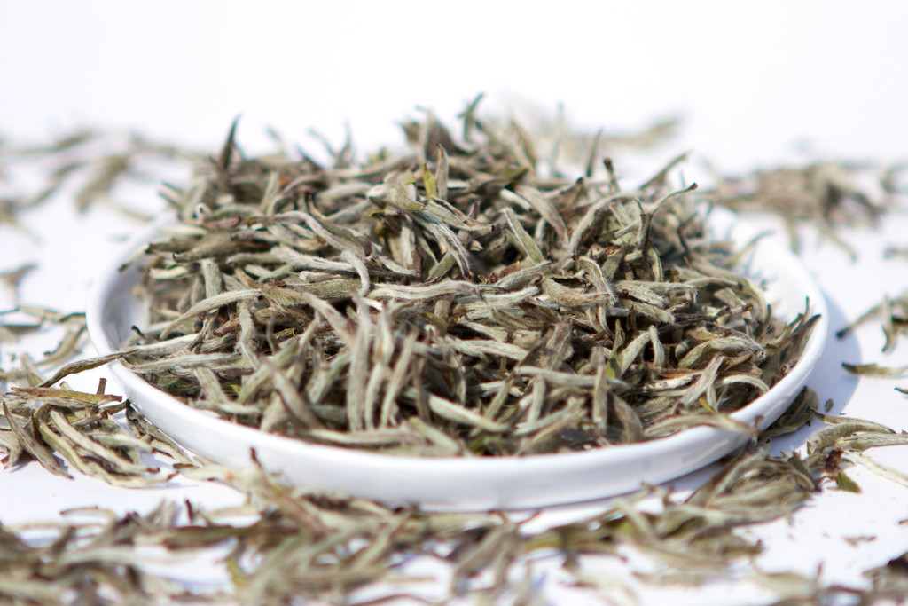 plate-of-loose-leaf-baihaoyinzhen-white-tea-silver-needle-from-fujian-china_1024x1024