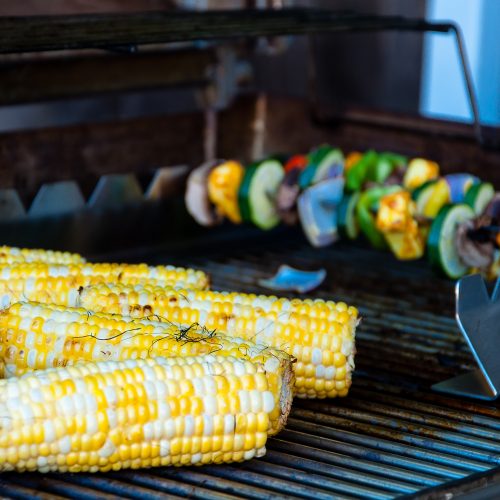 yellow corn and veggies on a grill